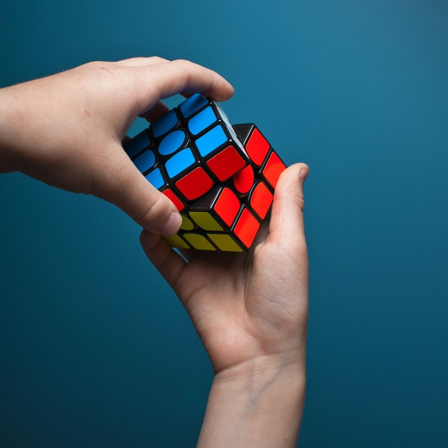 Hands solving a Rubik's cube